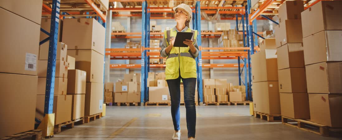 woman in a warehouse checking inventory