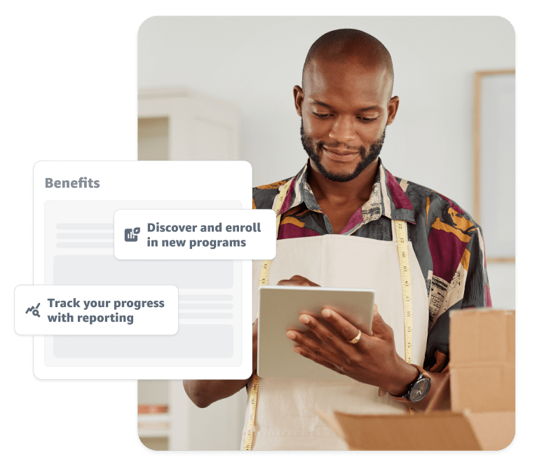 man using a tablet standing in front of boxes